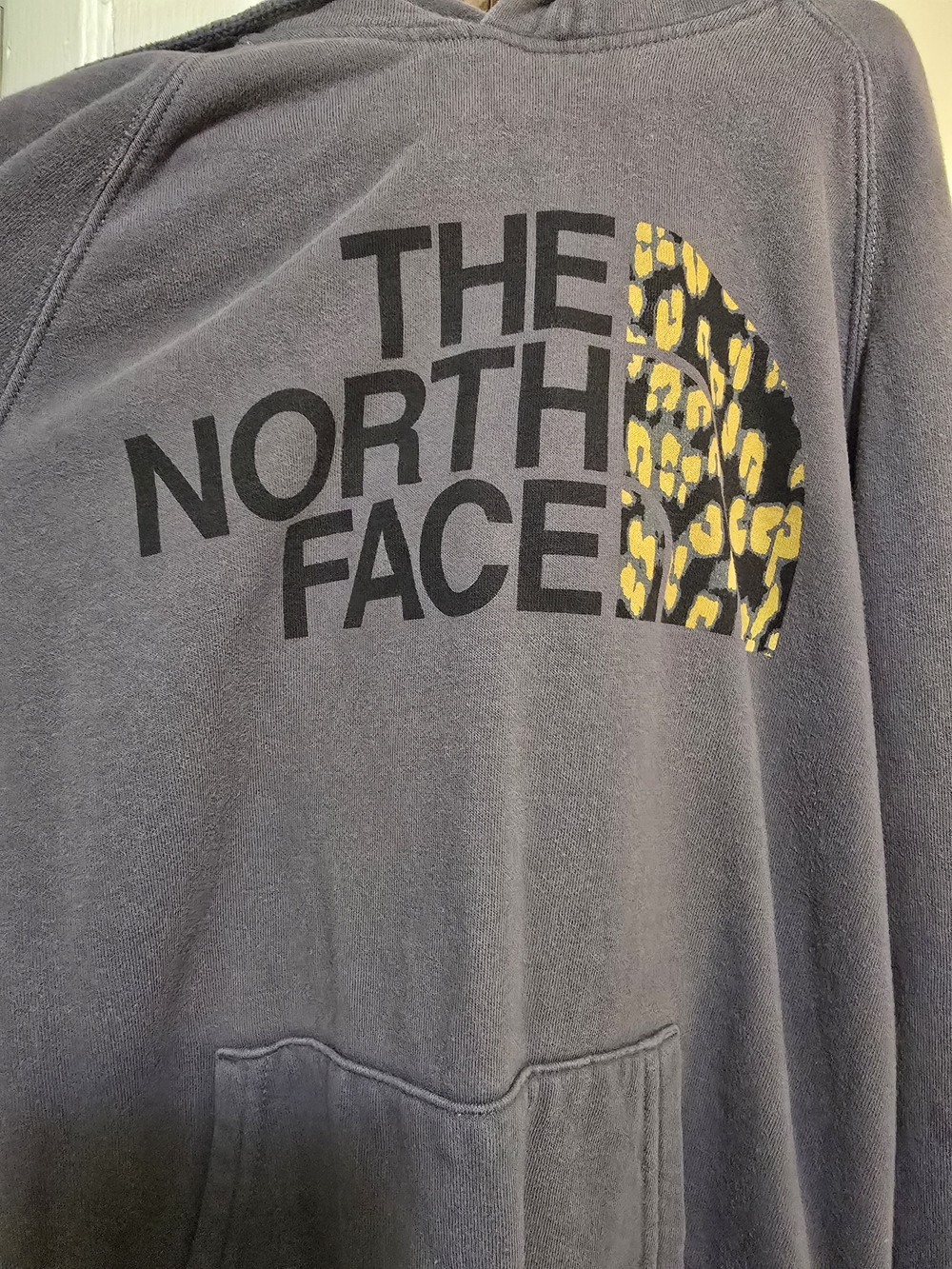 The North Face black and gray fleece hoodie label